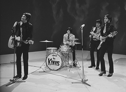 The Kinks onstage during a Dutch TV appearance in April 1967. Note Ray Davies' Fender acoustic guitar and Dave Davies' signature guitar, a prototype Gibson Flying V